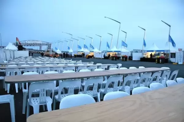 natural timber trestle tables with white plastic chairs