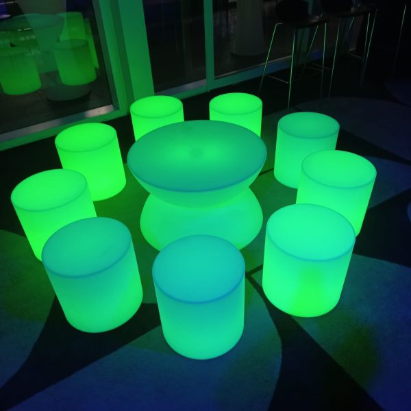 Glow coffee table and glow cylinder seats at en evening event