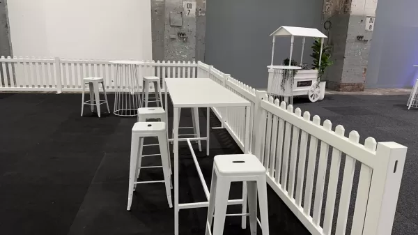 white tapas high bar table with white tolix stool and white picket fence