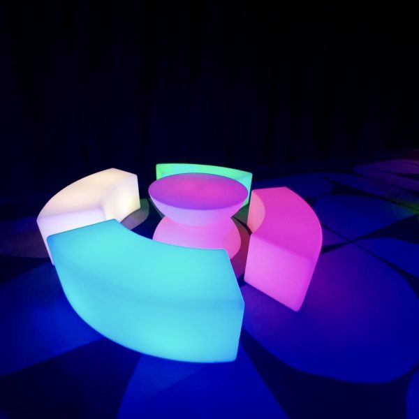 glow coffee table and glow cylinder seats at an evening event