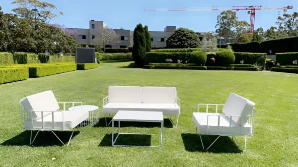 White rectangular coffee table and white wire sofa lounge and white wire arm chair