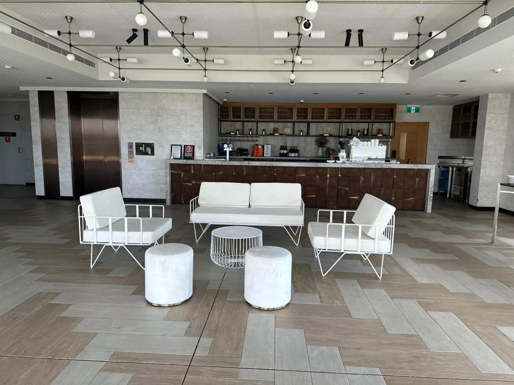 event with white wire arm chair, white wire sofa lounge, white wire coffee table and white velvet ottoman stool